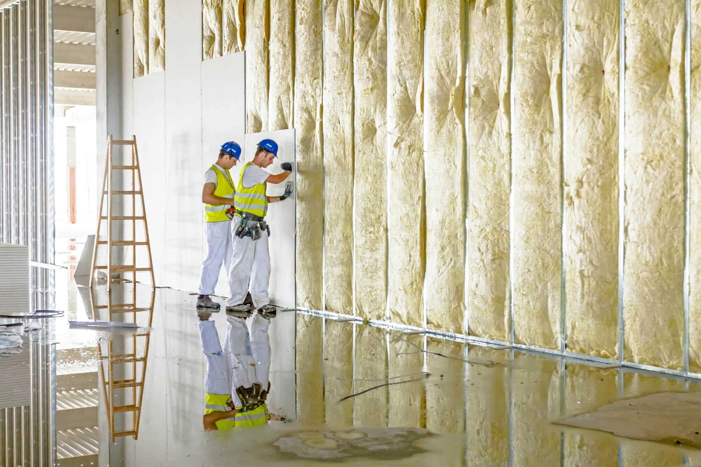Crew setting wall panels during a drywall installation