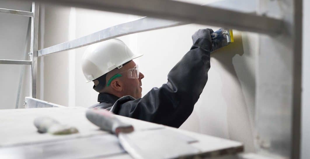 contractor repairing drywall