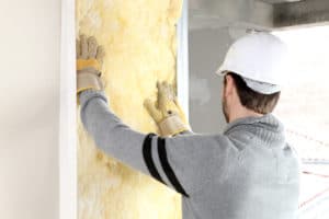 man insulates wall