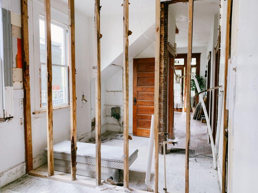 Home renovation showing exposed wall framing after storm damage assessment