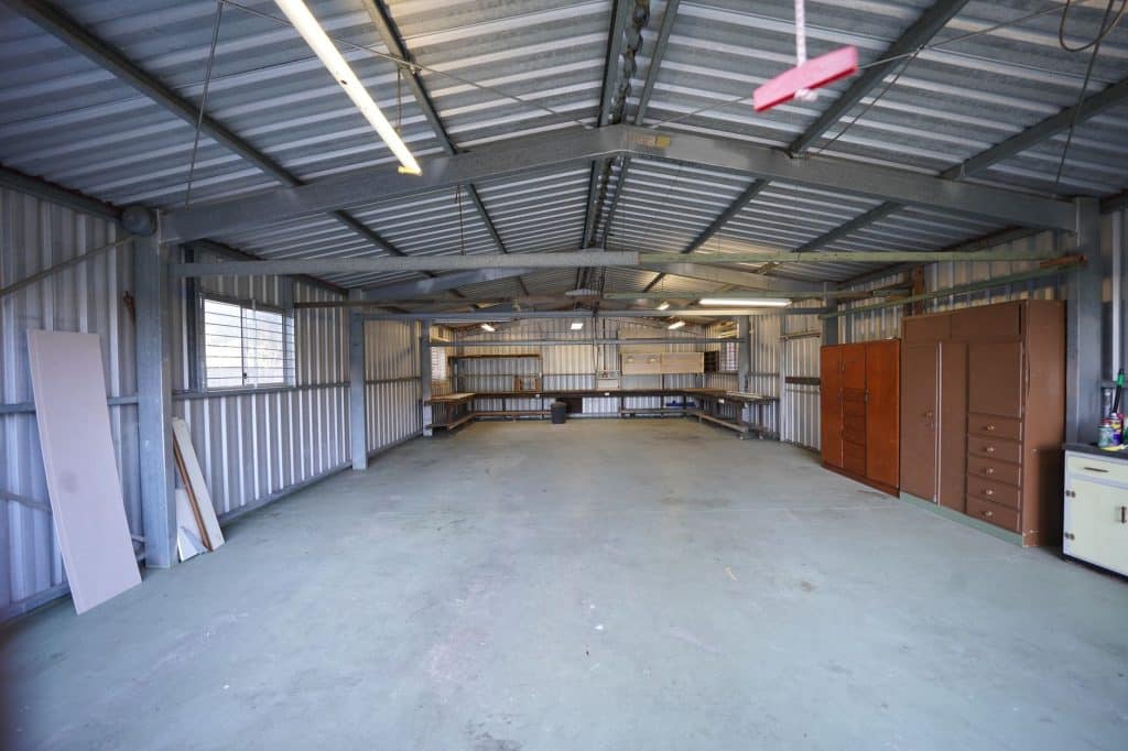 Empty garage interior with concrete floor ready for renovation