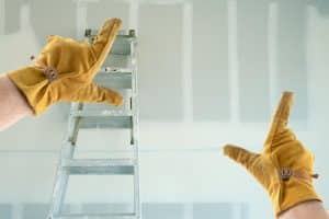 worker planning sheetrock installation