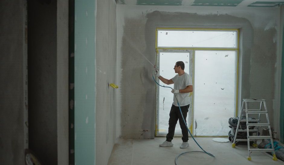Close-up, raking-light photo of a wall showing new drywall texture blending into existing texture at a seam line, ideall