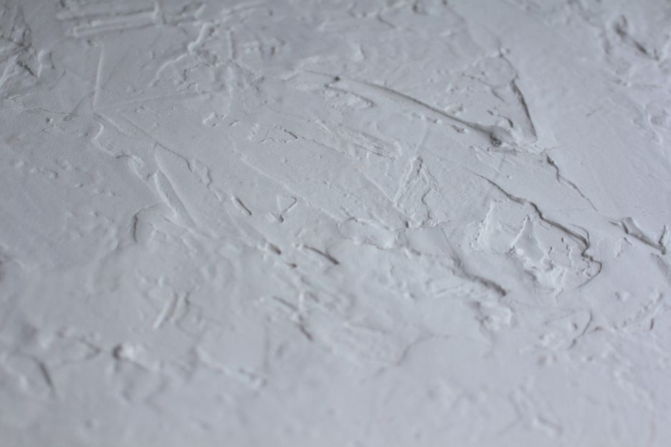 Finished, smooth painted wall in a New Orleans-style living or dining room, bright and move-in ready