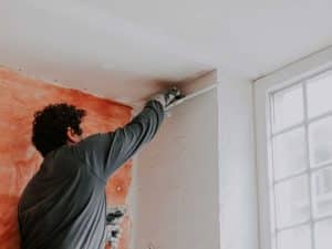 young man repairing drywall