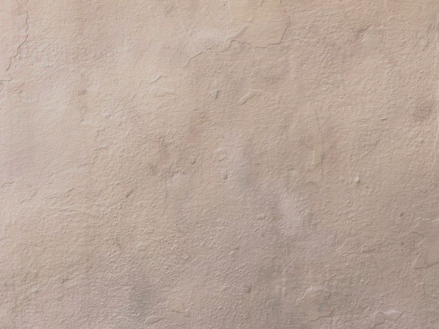 Close-up of a drywall seam being hand-textured to match an existing knockdown or orange-peel finish, showing the blend b